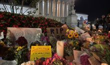 Photo of flowers and signs in front of US Supreme Court honoring Justice Ginsburg.